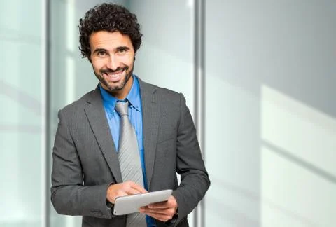 Handsome businessman using a digital tablet Stock Photos