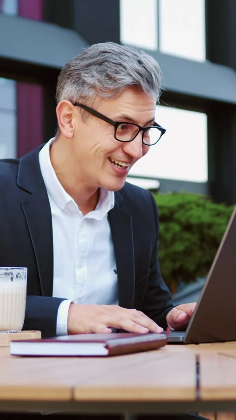 Handsome businessman using laptop computer celebrating win good message news Stock Footage 337943996