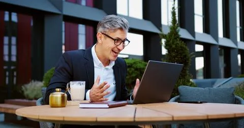 Handsome businessman using laptop computer celebrating win good message new.. Stock Photos