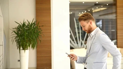 Handsome businessman using smartphone in the office Video stock 79305613