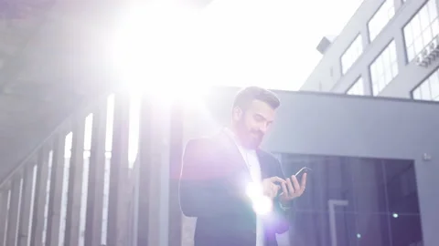 Handsome businessman using smartphone standing near business center. Happy Video stock 161718255