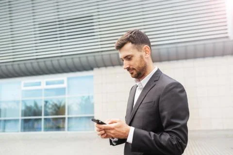 A handsome businessman using a smartphone. working by using smart phone in re Stock Photos
