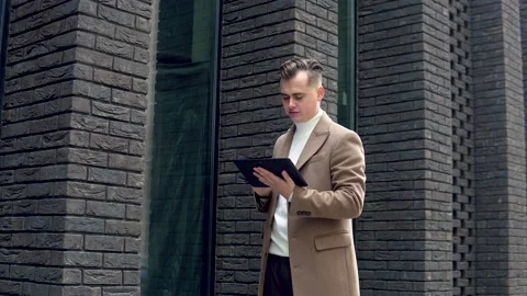 Handsome businessman using tablet. Young man texting messages, cheating on his 스톡 동영상 144885480