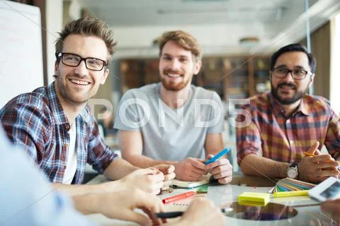 Handsome busisnessman listening to one of co-workers Stock Photos
