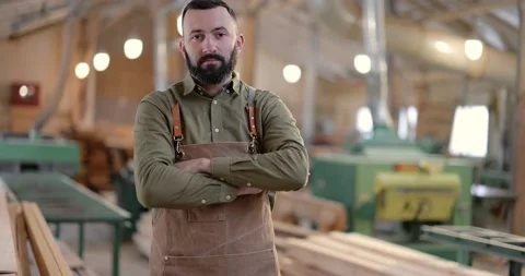Handsome carpentry worker in the joinery manufacturing Stock Footage 146912236