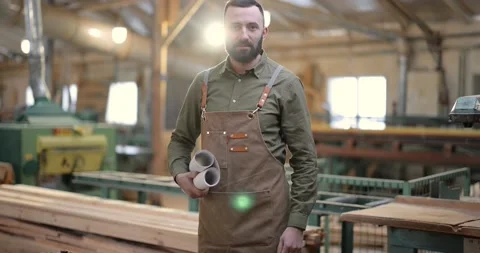 Handsome carpentry worker in the joinery manufacturing Stock Footage 146917477