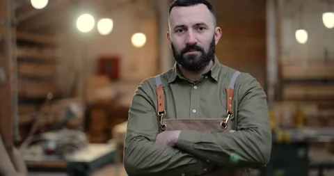 Handsome carpentry worker in the joinery manufacturing Stock Footage 146923977