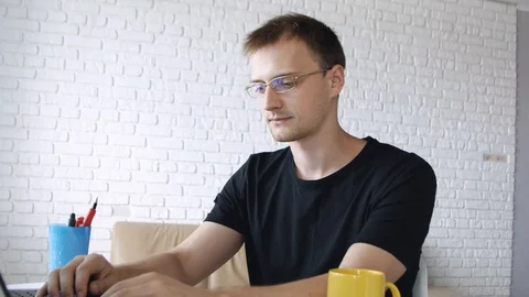 Handsome caucasian man making pause in he work, sitting and typing laptop, st 動画素材 111662248