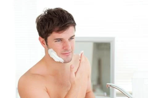 Handsome caucasian man ready to shave in the bathroom Stock Photos