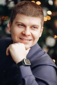Handsome caucasian man with short dark hair looks aside with his hand near the Foto stock