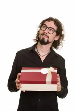 Handsome Caucasian man thinking while holding git box ready for Stockfoto's