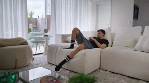 Handsome caucasian man using cellphone on the sofa. Video stock 249018274
