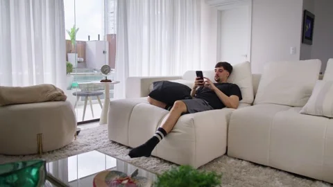 Handsome Caucasian Man Using Smartphone in Cozy Living Room at Home. Stock Footage 249017356