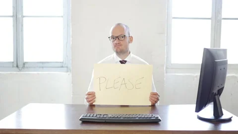 Handsome caucasian worker with office work related signs messages: Please, Stock-Footage 143302539