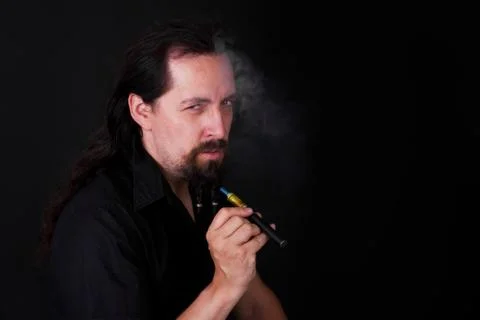 Handsome caucasion man smoking e-cigarette Stock Photos