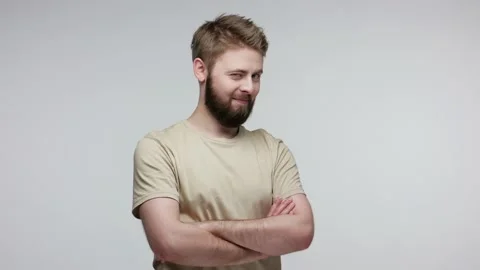 Handsome cheerful bearded guy looking at camera, smiling playfully and winking Stock Footage 134093092