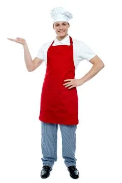 Handsome chef presenting copy space Fotos Stock