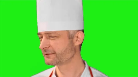Handsome chef turns head, smiling at the camera and turns back on a green Video stock 71352769
