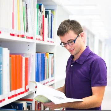 Handsome college student in library (shallow DOF; color toned im Stock Photos