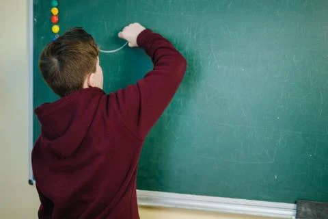 Handsome college student solving a math problem during math class Stock Photos