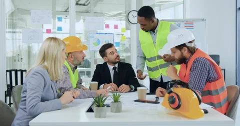 Handsome confident black-skinned engineer standing near bearded ceo and Stock Footage 145607830