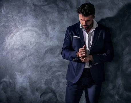 Handsome, confident, elegant man posing in fashionable suit, wearing luxury h Stock-Fotos