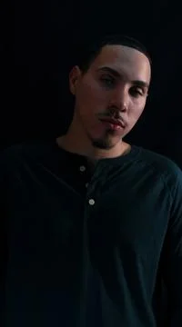 Handsome confident mixed man portrait isolated over black background. Stock Photos