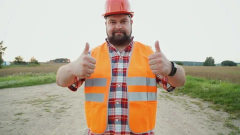 Handsome constructor showing thumbs up and smiling Stock Footage 90885800
