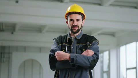 Handsome constructor worker man crossing hands and posing charismatic in front Stock Footage 191549724
