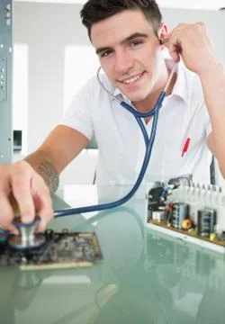 Handsome content computer engineer holding stethoscope Stock Photos