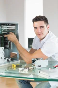 Handsome content computer engineer working at open computer Stock Photos