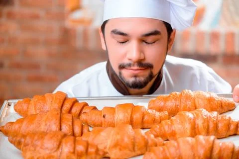 Handsome cook in the kitchen Stock Photos