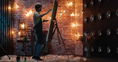 Handsome Creative Artist Painter is creating on Loft Art Studio. Back View. Video stock 141582468