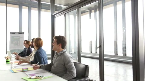 Handsome creative director giving presentation, colleagues are smiling Stock Footage 59544054