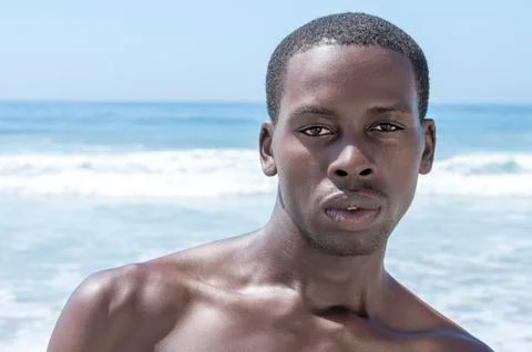 Handsome dark summer beach stud Photos