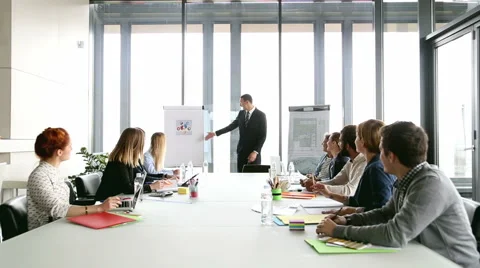 Handsome director pointing at flipchart during a meeting Stock Footage 59543976
