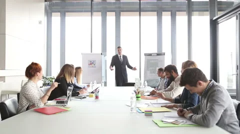 Handsome director pointing at flipchart during a meeting Stock Footage 59543983