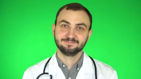 Handsome doctor man looking at camera and smiling green screen background Stock Footage 172065526