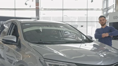 Handsome driver leaning on his beautiful new car. Stock Footage 99773485