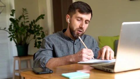 Handsome Eastern European man studying remotely at home during Corona virus Stock Footage 129495770