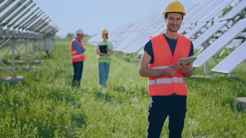 Handsome ecological engineer with safety helmet looking to the camera and posing Stock Footage 233578254
