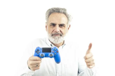 Handsome elder silver-haired caucasian man holding blue gamepad and showing Stock Photos
