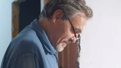 Handsome elderly architect talking to workers Video stock 114570670