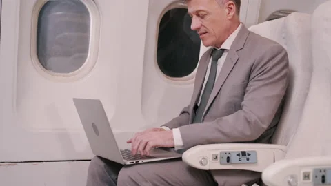 Handsome Elderly Businessman working with digital laptop computer on the plane Stock Footage 150348983