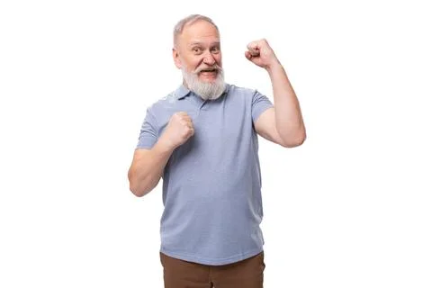 Handsome elderly man with a gray beard and mustache in a t-shirt feels cheerful 스톡 사진