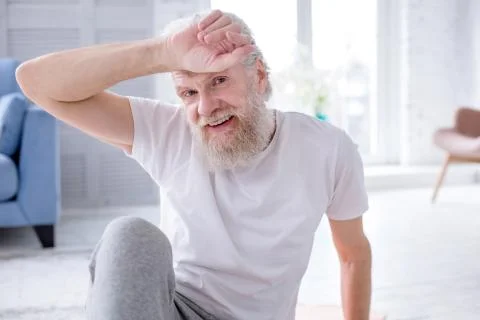Handsome elderly man resting after working out Stock Photos