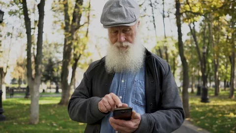 A handsome elderly man wearing glasses and using a phone. Stock Footage 129331872
