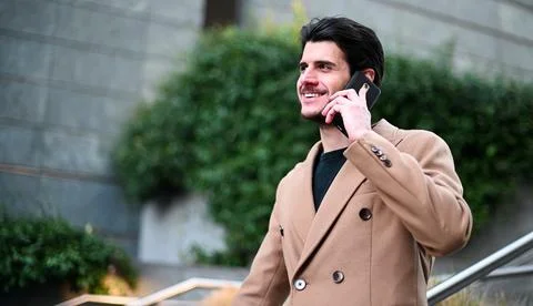 Handsome elegant dressed man talking on the phone Photos
