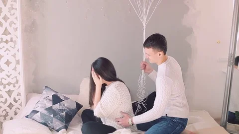 Handsome elegant guy is presenting a gift card and balloons to his beautiful 스톡 동영상 74025828