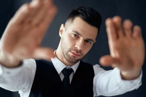Handsome elegant man looking through a finger frame Foto stock